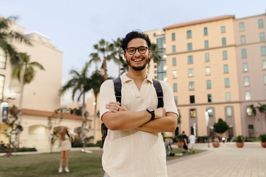 biblical studies minor student stands with arms folded on the PBA campus.